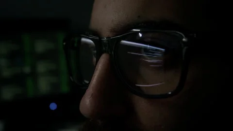 Eyes Focused on Computer Screen with Lines of Code Reflecting in Glasses Stock Footage 302194882