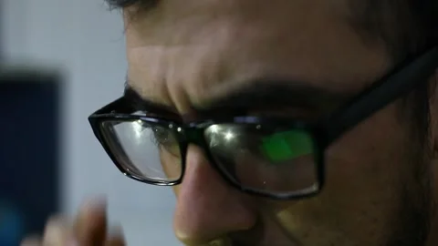 Eyes with glasses, the guy is working at the computer Stock Footage 269162271