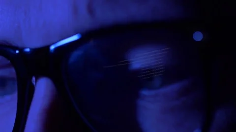 Eyes in glasses reflecting computer code Stock Footage 82570590