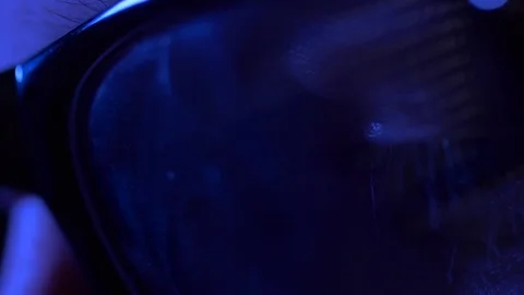 Eyes in glasses reflecting computer code 스톡 동영상 82786516