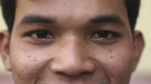 Eyes of happy young asian man looking at camera Stock Footage