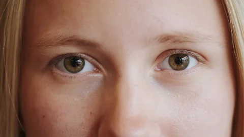 Eyes looking in camera, face close up portrait of young woman with blond hair Stock Footage 171134699