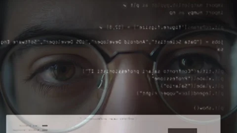 The eyes of a man working on the computer with the code Stock Footage 129442549