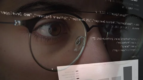 The eyes of a man working on the computer with the code Stock Footage 129442674