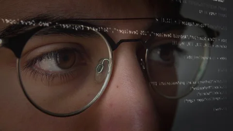 The eyes of a man working on the computer with the code Stock Footage 129442791