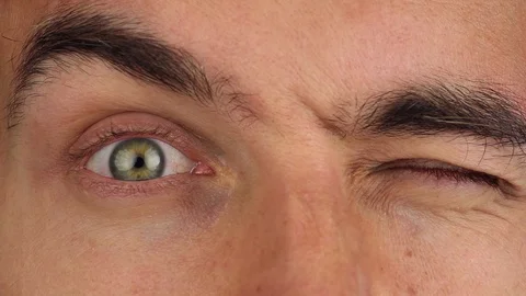 Eyes opens in panic, closes eyelid, one opens, second, pupils constrict, closeup Video stock 94364044