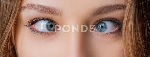 Eyes with squinted look and eyebrows on male face. Female eyes with strabismus Stock Photos