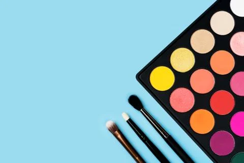 Eyeshadows on blue background Stock Photos