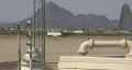An F-15 after landing rolls behind C-130 HD Footage