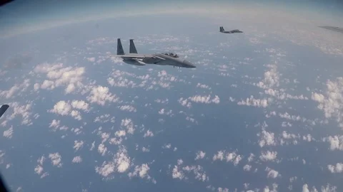F-15 Eagle approaching boom side on for aerial refuel above Pacific Ocean Stock Footage 103675979