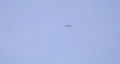 F-15 Eagle in a distance with light flash from sun. HD Footage