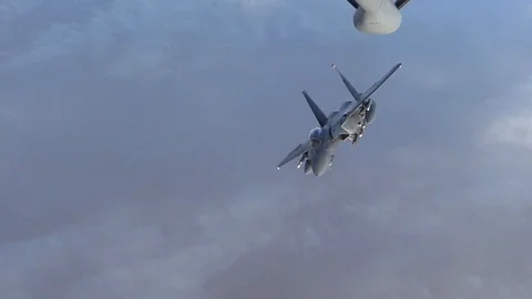 F- 15E Eagle peels away and deplys flares after air to air refuel Stock Footage 87688977