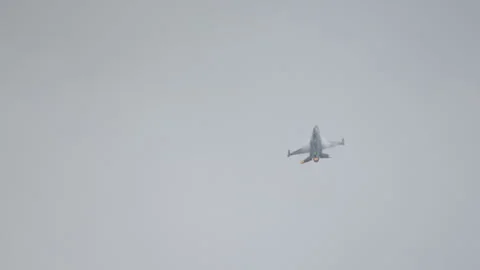 F-16 fighter jet performing maneuvers during an airshow demonstration Stock Footage 246132243