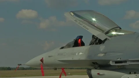 F-16 Fighting Falcon parked with canopy open and remove before flight tags Stock Footage 94699238