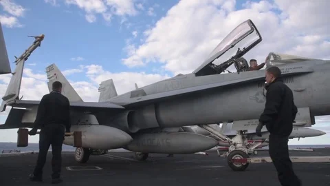 F/A 18 being pushed back by tug on board USS Dwight D Eisenhower Stock Footage 83849387