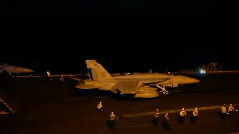 F/A-18 Hornet preparing for take off from USS Carl Vinson CVN 70 at night Stock Footage 161794433