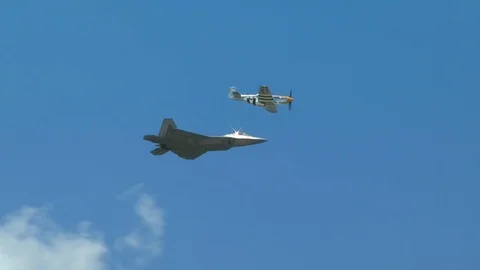 F-22 Raptor and P-51 Mustang left to right flyby Stock Footage 91754852