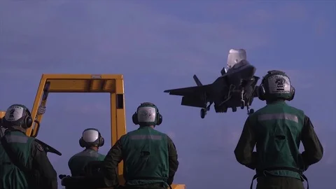 F-35 Fighter Bomber Hovering in the Air, Against the Background of Signalmen Video stock 120951893