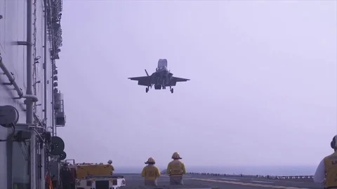 F-35 fighter-bomber performs a vertical landing on the deck of the ship Stock Footage 120949909