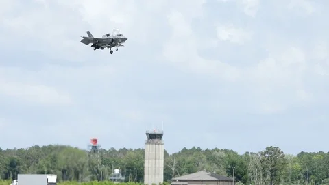 F-35 hovers over a runway and control tower Stock Footage 75215286