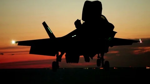 F-35 Jet fighter hovers slowly onto an aircraft carrier Stock Footage 111849094