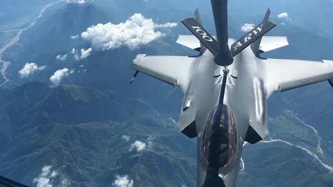 F-35 Lightning II conducts aerial refuel above mountains of Italy Stock Footage 109271429