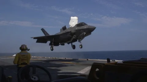 F-35B Lightning II conducts vertical landing aboard USS Wasp in Philippine Sea Stock Footage 102768941