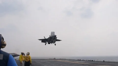 F-35B Lightning II landing aboard amphibious assault ship USS Wasp Stock Footage 105156760
