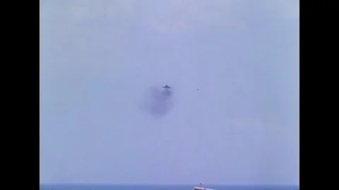 F-4B on a landing approach, smoke pouring from tail pipe, T-2A makes a fly-over, Stock Footage 117053331