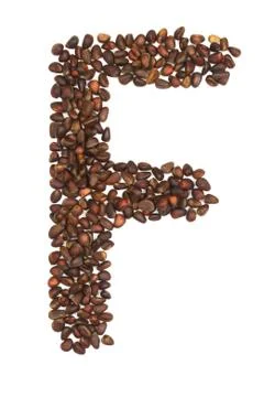 F letter made of cedar  nuts Stock Photos