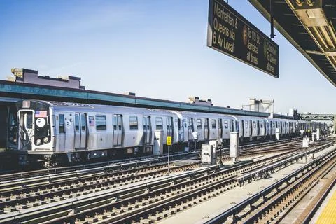 F subway train approaching elevated station in Brooklyn, New York. Train trac Stock Photos