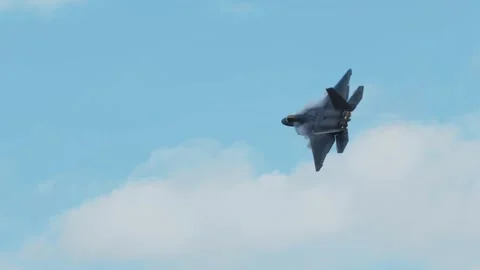 F22 Raptor banking and performing acrobatic maneuvers in the sky Stock Footage 332874127