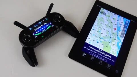 FAA Drone Pilot Using LAANC System on iPad for Airspace Authorization Stock Footage 342571470