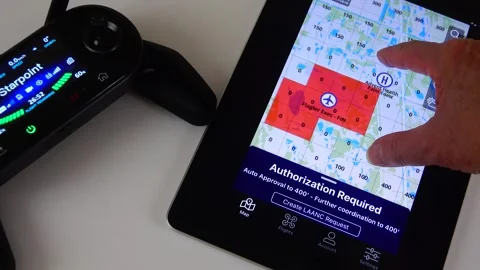 FAA Drone Pilot Using LAANC System on iPad for Airspace Authorization Stock Footage 342571705