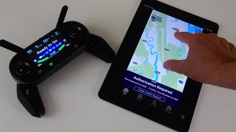 FAA Drone Pilot Using LAANC System on iPad for Airspace Authorization Stock Footage 342572683
