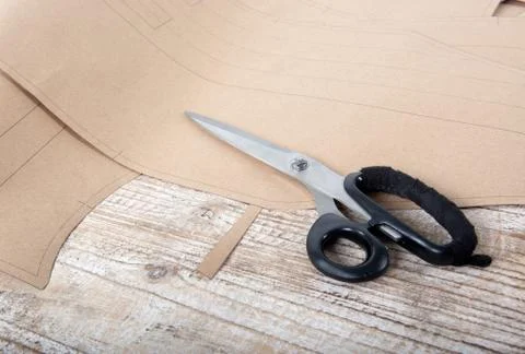 Fabric and objects for sewing clothes. Roulette and patterns on the table Stock Photos