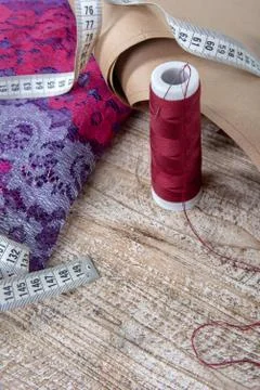 Fabric and objects for sewing clothes. Roulette, coil, and patterns on the ta Stock Photos