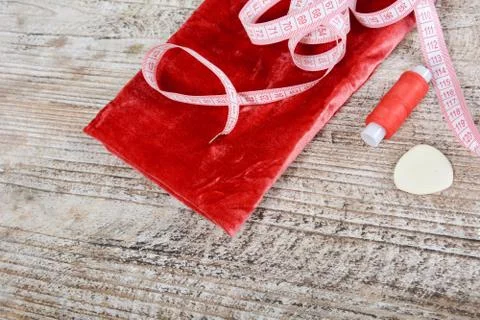 Fabric and objects for sewing clothes. Roulette, coil, and patterns on the ta Stock Photos