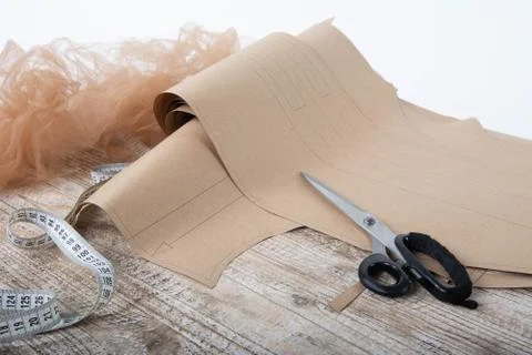 Fabric and objects for sewing clothes. Roulette and patterns on the table Stock Photos