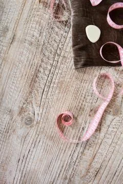 Fabric and objects for sewing clothes. Roulette, coil, and patterns on the ta Stock Photos