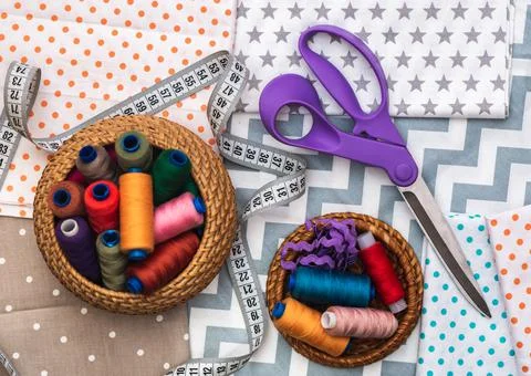 Fabric and objects for sewing. Cotton fabric is stacked. A centimeter tape Stock Photos