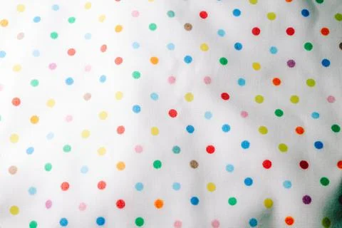 Fabric background with pattern. Rainbow balls on the fabric. Stock Photos