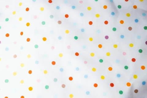 Fabric background with pattern. Rainbow balls on the fabric. Stock Photos