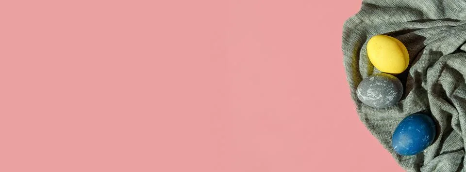 Fabric banner with colorful Easter eggs in pastel colors on a pink background Stock Photos