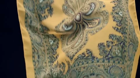 Fabric with beautiful asian patterns falls, fluttering on a black background Stock Footage 303178900