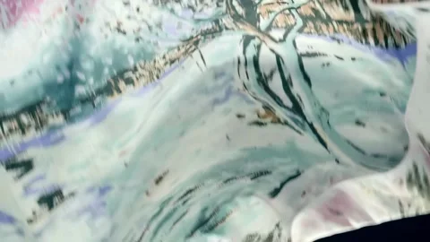 Fabric with beautiful flora patterns falls, fluttering on a black background Stock Footage 303178856