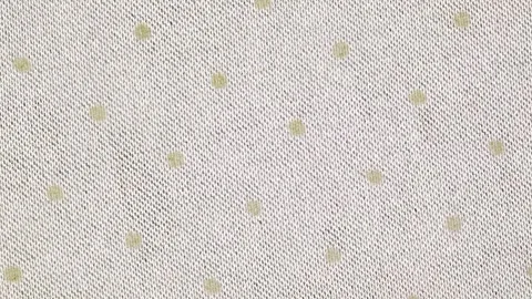 Fabric beige close-up with round dots, woven surface rotating, turning Stock-Footage 240654463