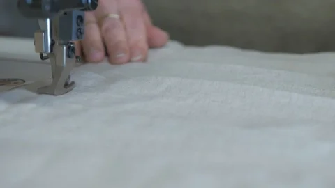 Fabric being fed through sewing machine 4K Stock Footage 124831084