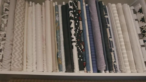 Fabric Bolts with Patterns and Textures on Store Shelf Stock-Footage 323949923