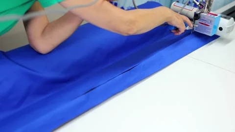 Fabric cutting machine with built-in tape measure. Sewing workshop. Stock Footage 309798645